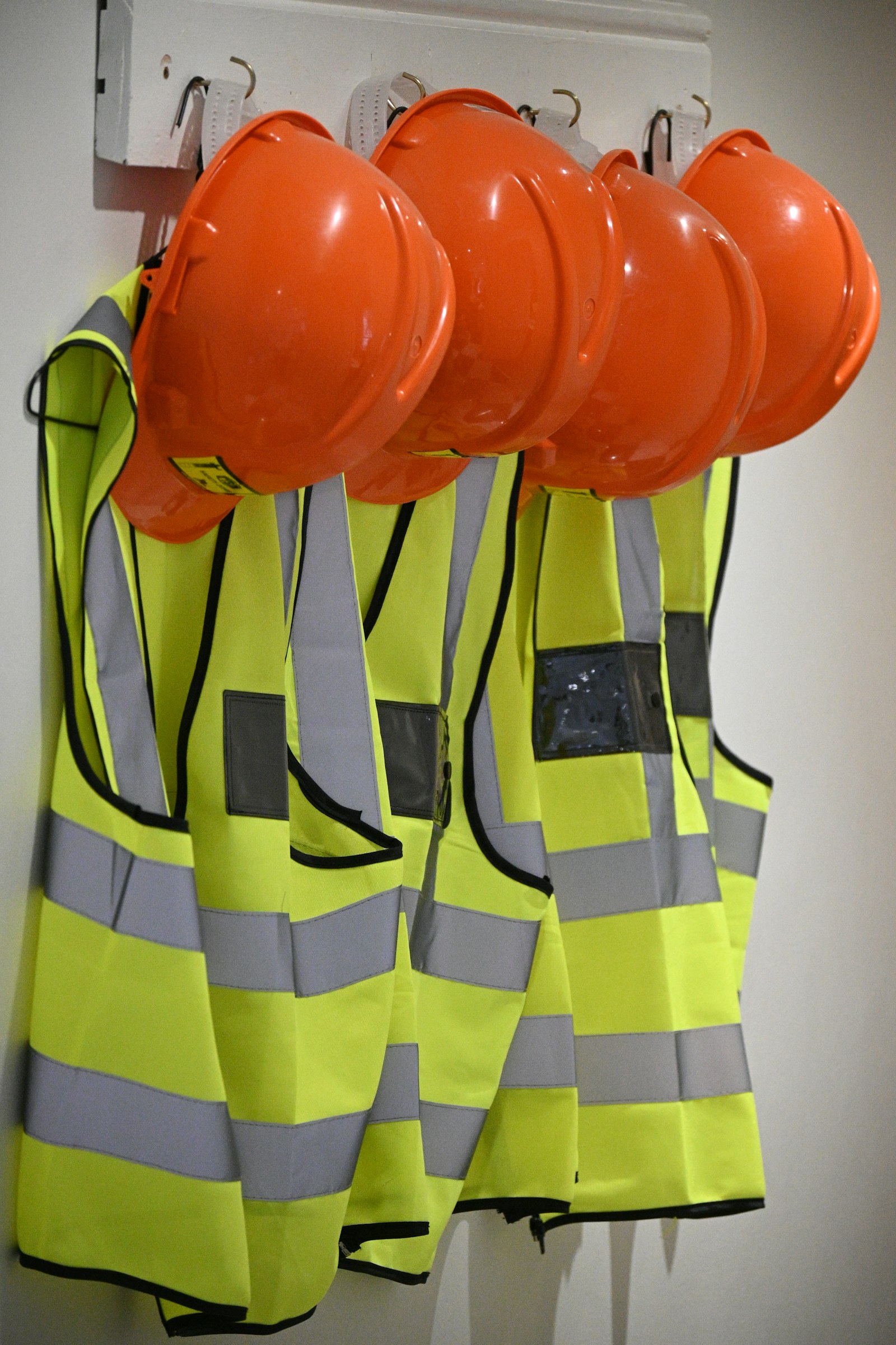 Hard hats and branded hi-vis vests kit-ready for a Bradford construction crew