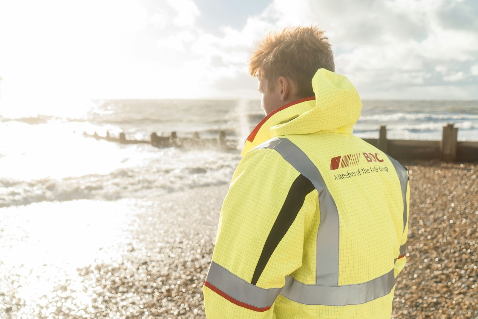 Worker in hi-vis jacket with embroidered branding across the back yoke