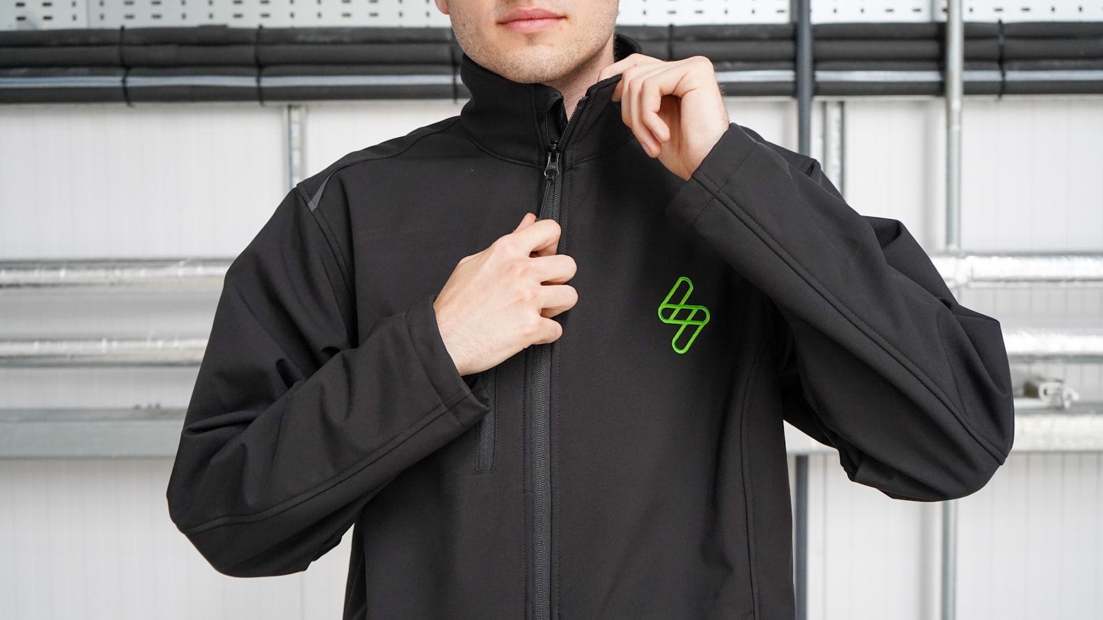 Embroidered left-chest logo on a softshell jacket for site teams