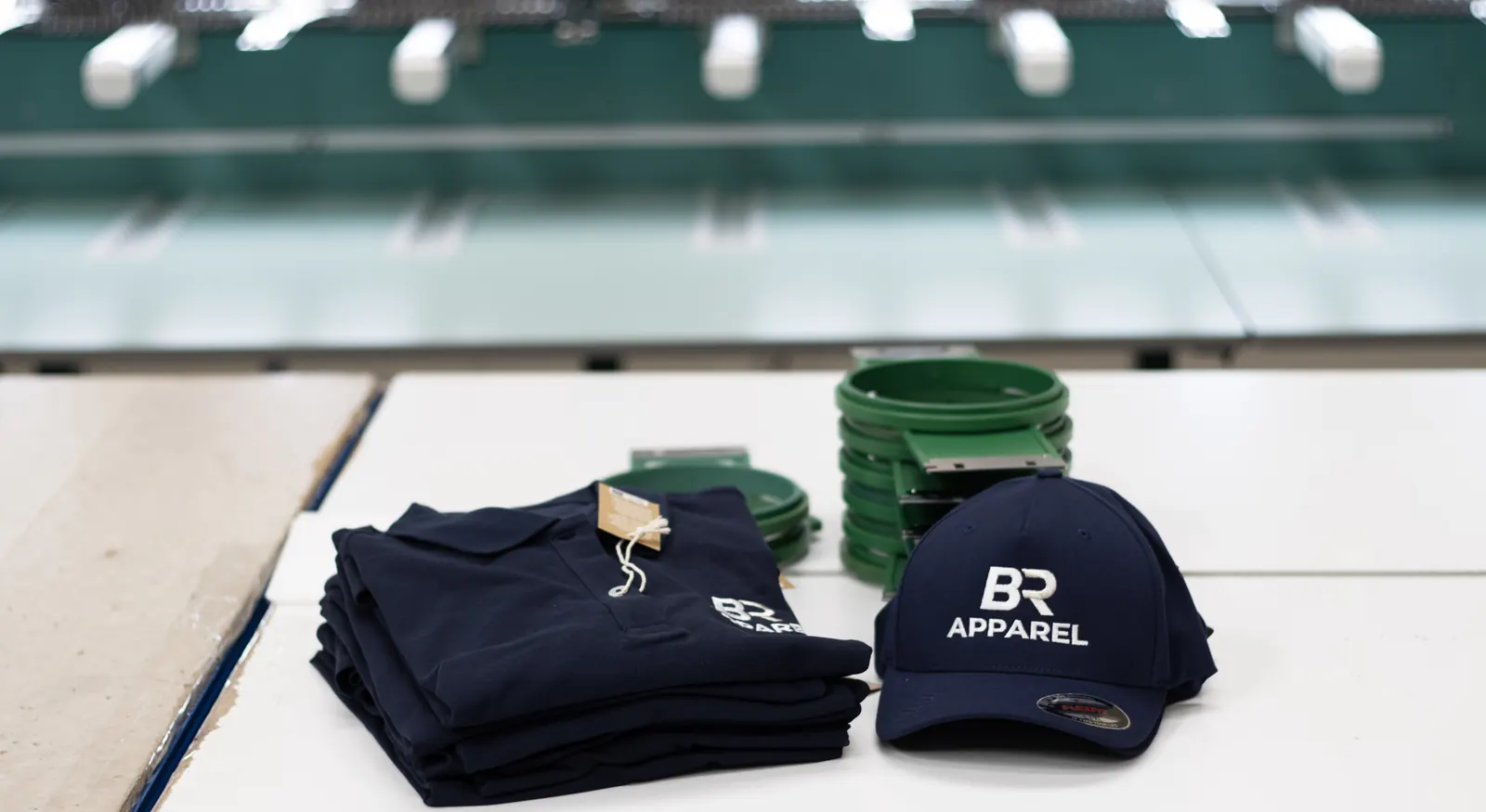 Folded embroidered polo shirts and a branded cap ready for dispatch
