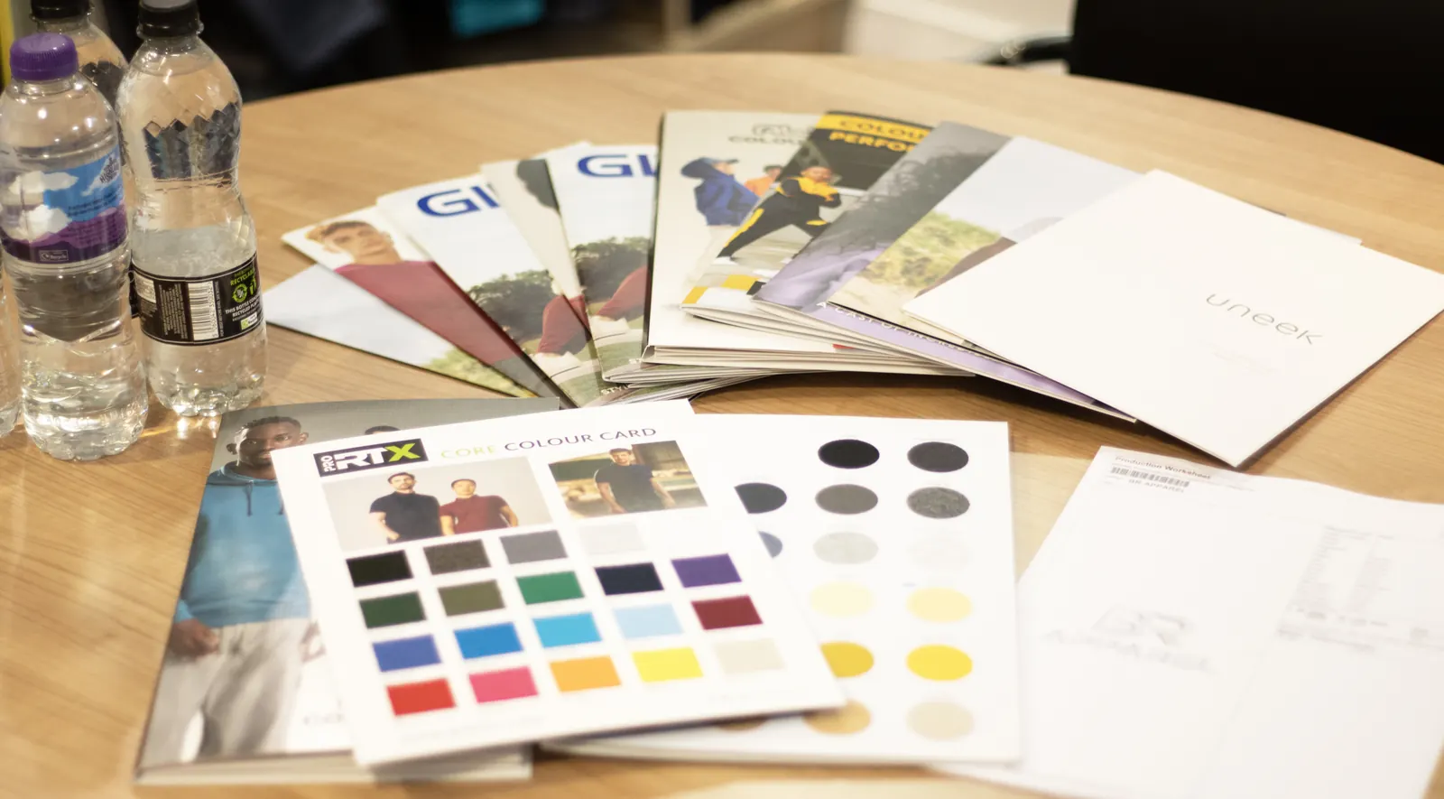 Garment brochures and colour cards used to plan a uniform range at BR Apparel