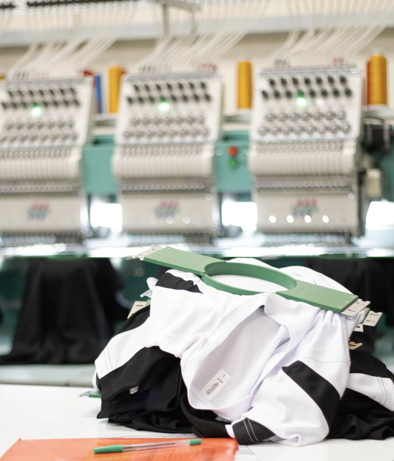 Garments staged at the embroidery machine line at BR Apparel in Bradford