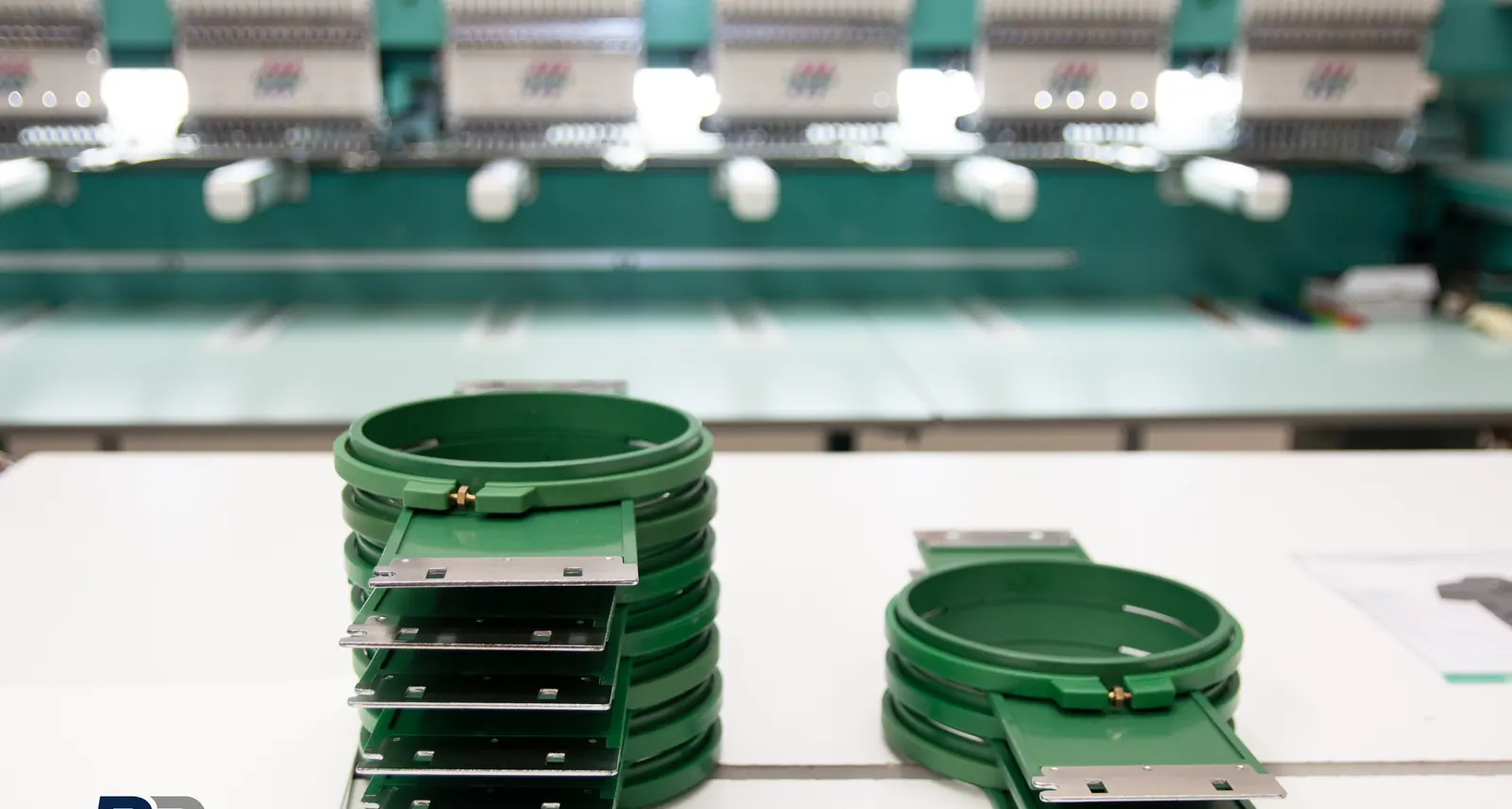 Embroidery hoops stacked ready for a Leeds uniform run at BR Apparel