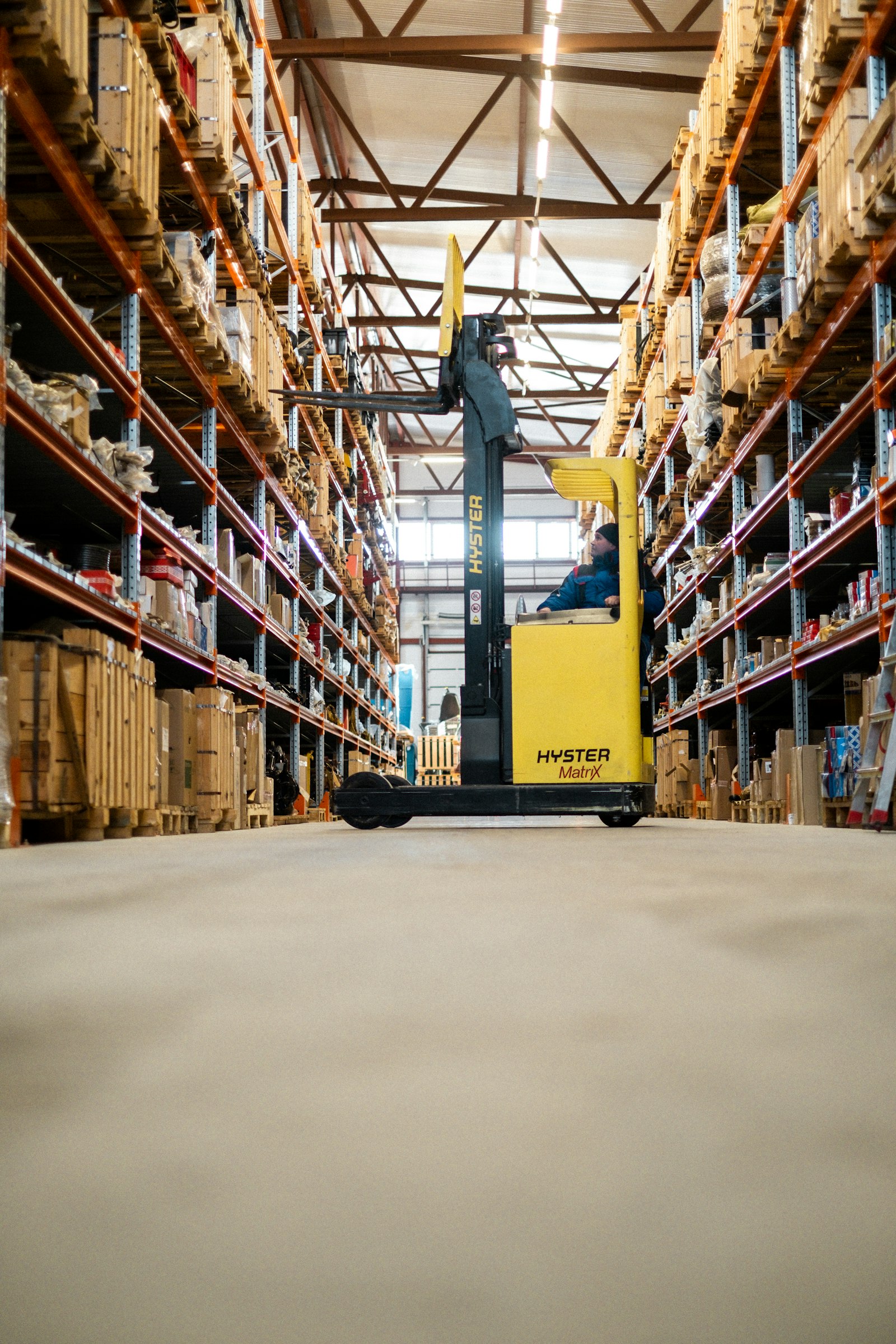 Forklift moving stock between aisles in a Bradford warehouse