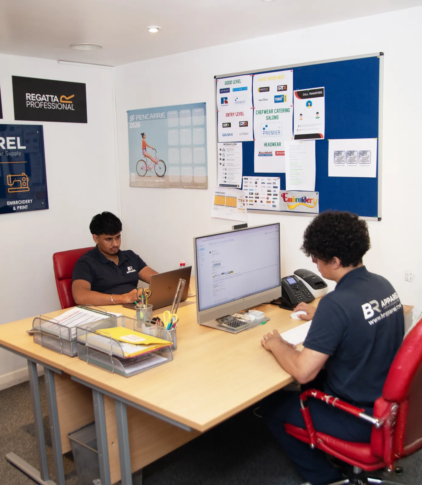 BR Apparel team reviewing a uniform quote for a business client