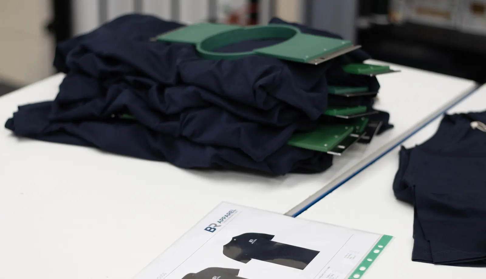 Pre-approved branded uniform garments laid out for an approved uniform range at BR Apparel